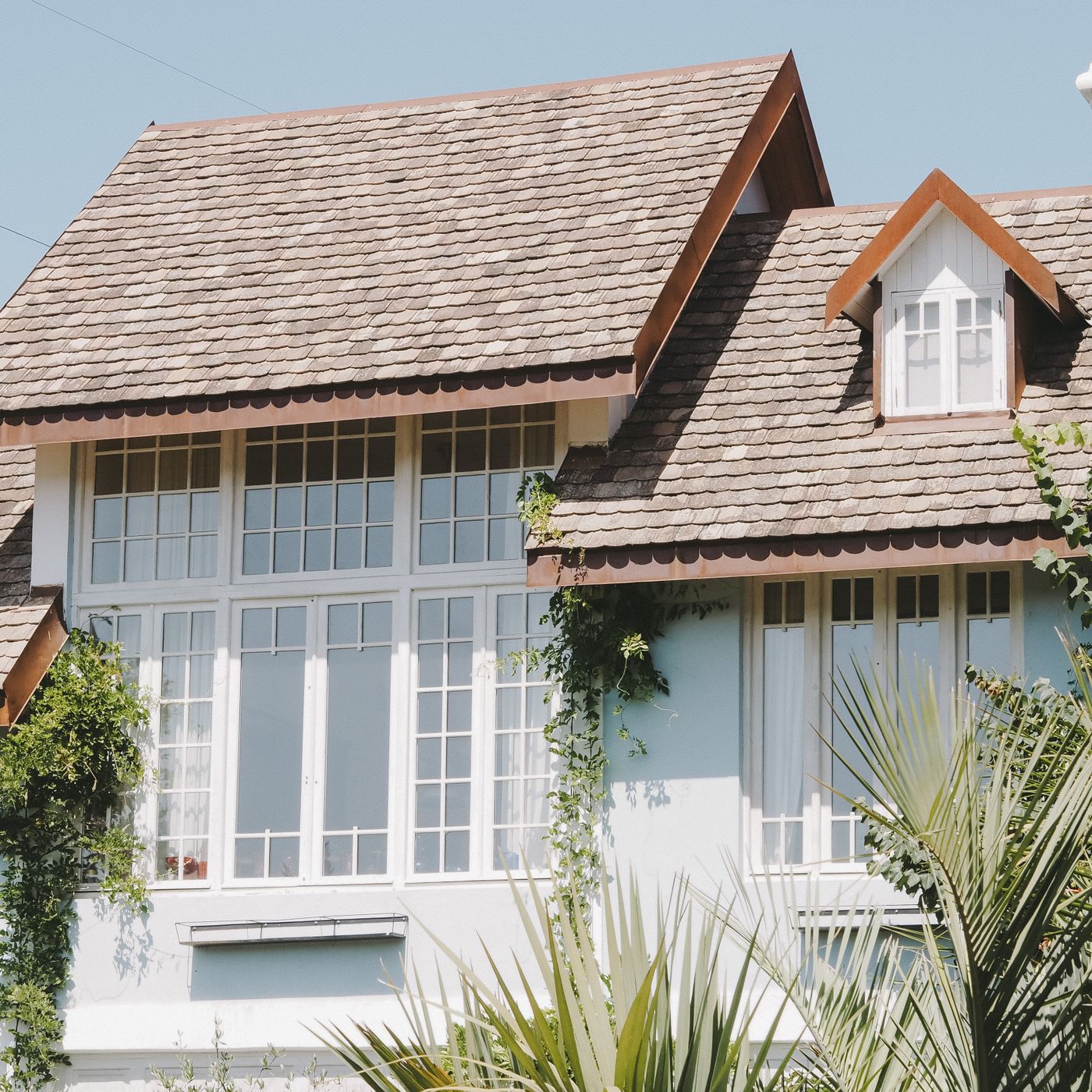 Finished residential home with a steep architectural shingle roof